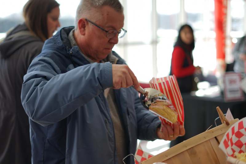 a man holding a spoon in front of a basket