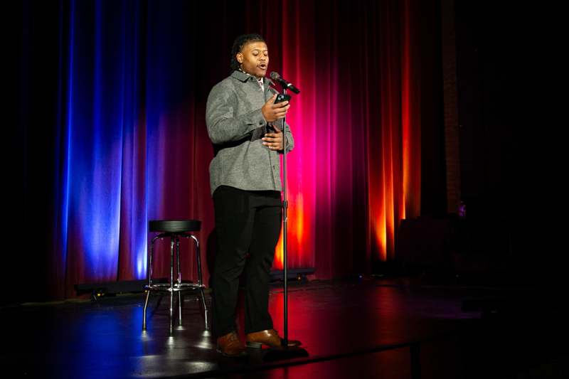 a man standing on a stage with a microphone