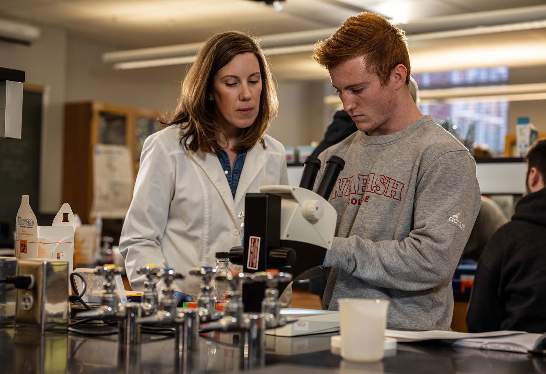 a professor and student working in a lab