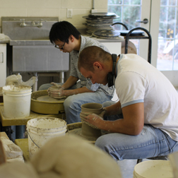 Non majors working in a pottery class.